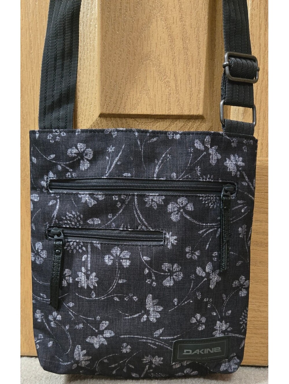 Dakine Black Crossbody Bag with Grey Floral Print and Adjustable Strap